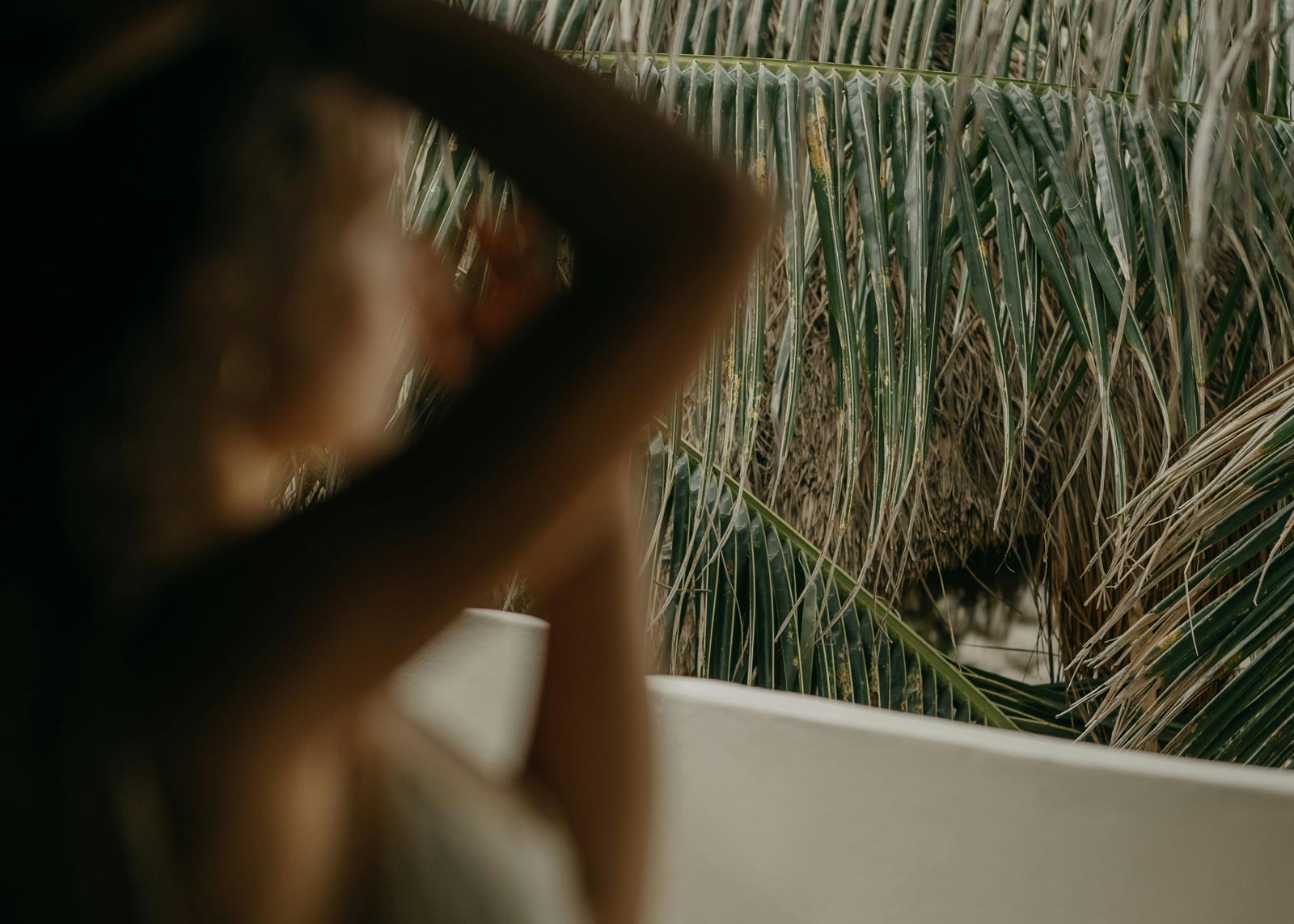 Soft focused woman with palms in background